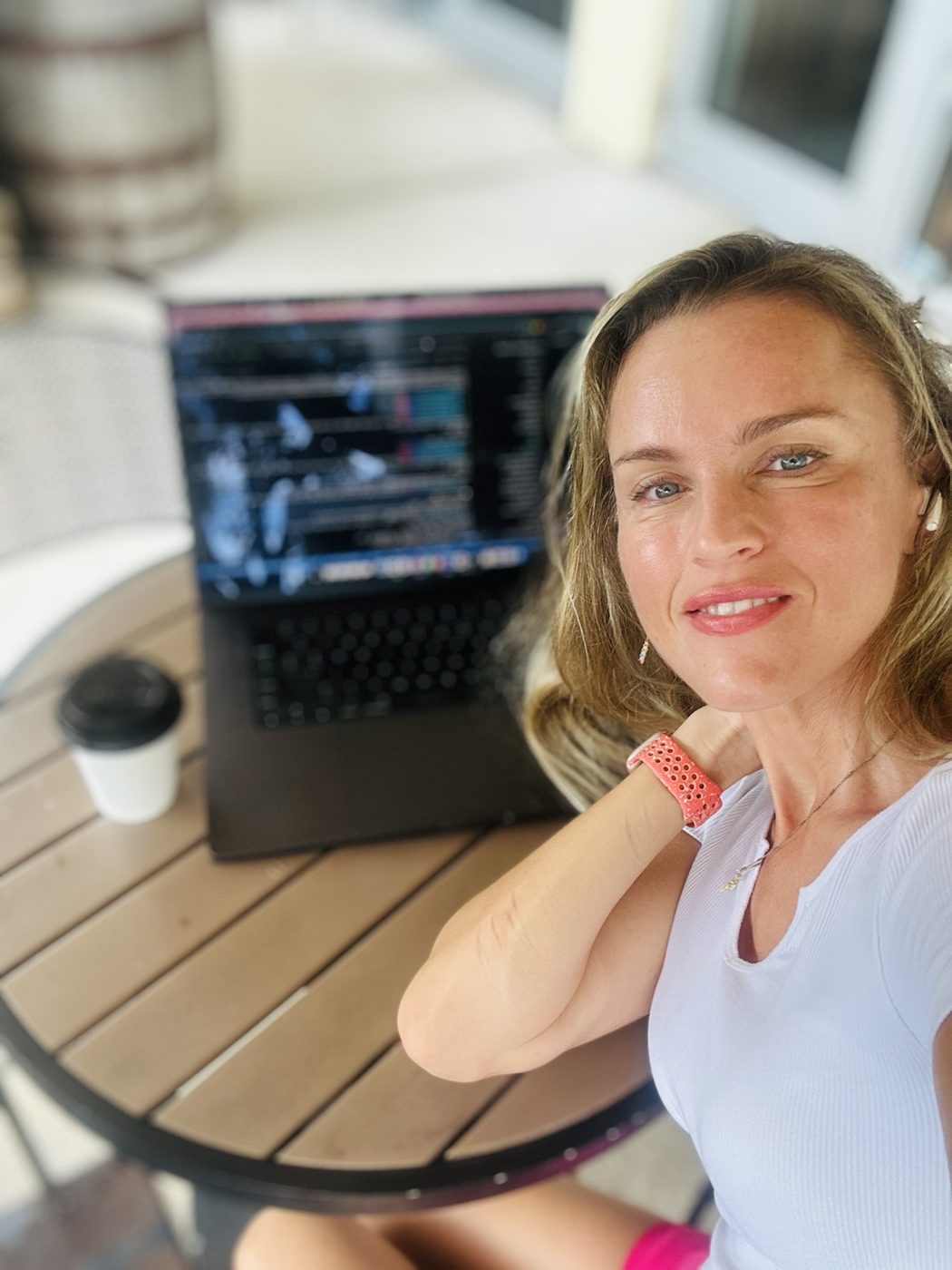 Maria working at her laptop at an outdoor café